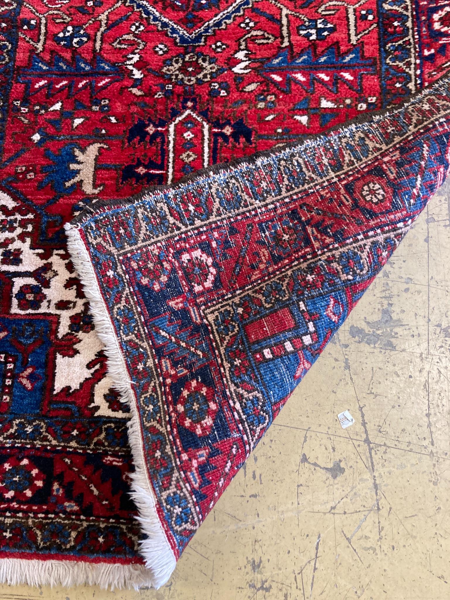 A North West Persian red ground hall carpet, 440 x 115cm